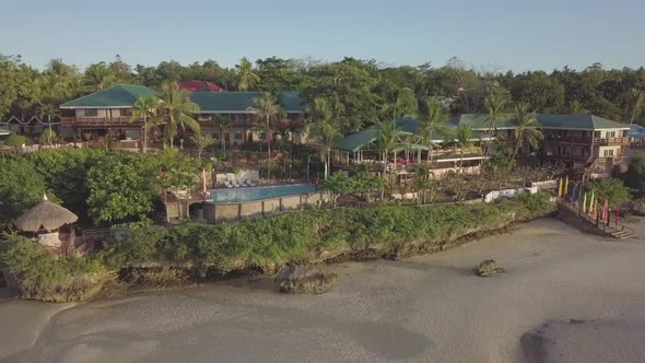 Revealing incredible, luxury, island resort. Drone panning shot