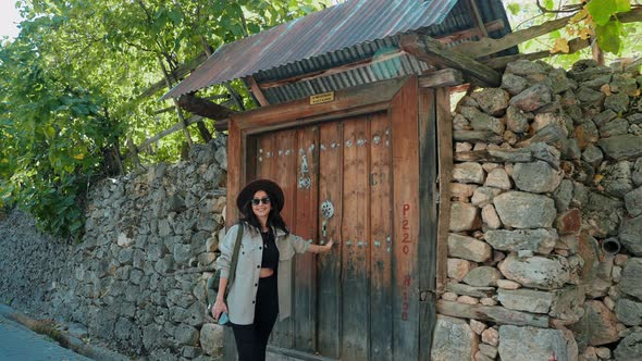 Woman in Front of Historical Door