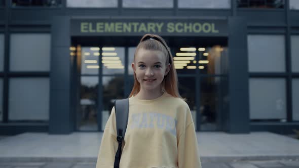 Teenage School Girl Posing at Campus Entrance Close Up