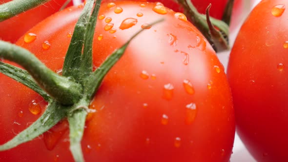 Red  wet tomato on the white surface food  4K 2160p 30fps UltraHD  slow tilt footage - Water drops o