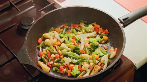 Slow Motion Closeup of Frying Vegetables in Pan with Steam and Without Lid