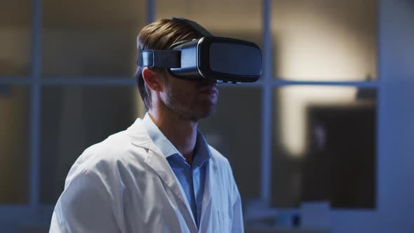 Caucasian male doctor wearing vr headset using virtual interface