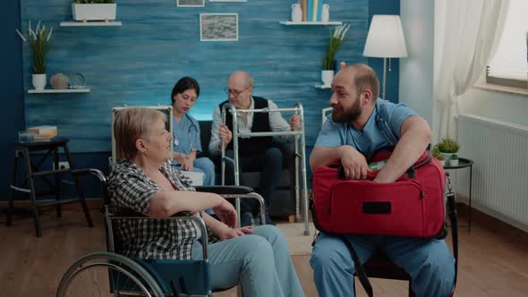 Senior Woman with Handicap Receiving Treatment From Nurse