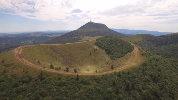 Aerial travel drone view of the Puy de Dome, lava dome volcano in France.