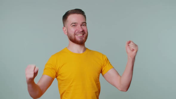 Trendy Man in Tshirt Shouting Raising Fists in Gesture I Did It Celebrating Success Winning