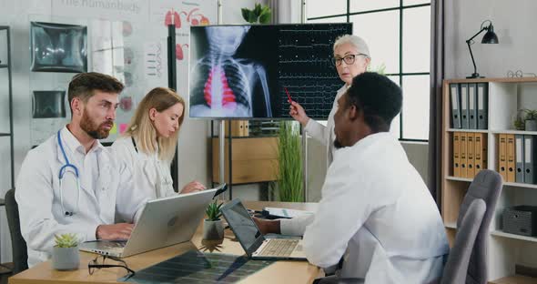 Female Doctor Explaining Chest X-ray, Lungs Scan and Heartbeat on Digital Screen