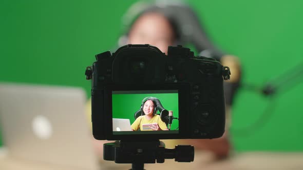 Camera Display Of Asian Kid Girl Hold Phone And Talking To Camera While Live Stream On Green Screen