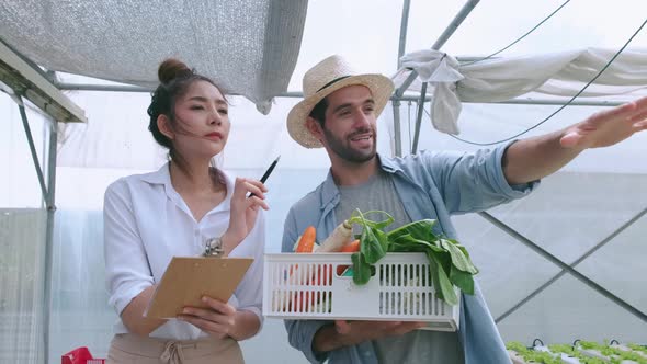 handheld asian female partner with caucasian farmer discussing about business in hydroponics