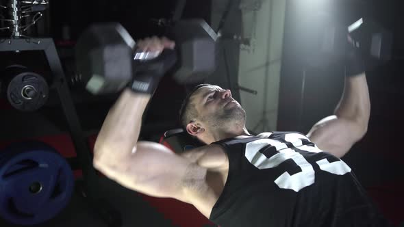 Brutal Man Shakes His Chest Dumbbells