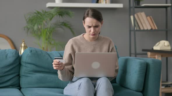 Woman with Unsuccessful Online Payment on Laptop on Sofa