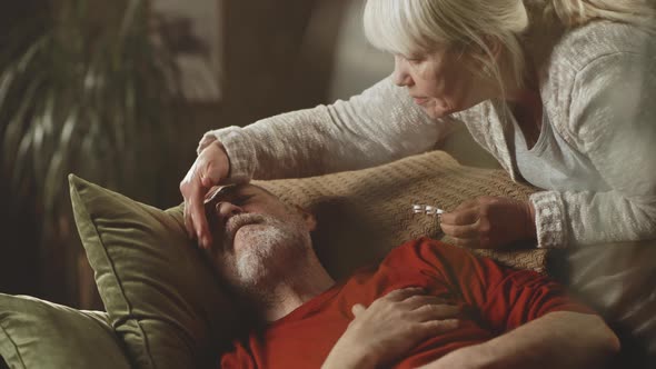 Aged Wife Taking Care of Ill Husband