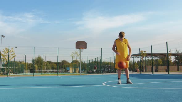 Young boy with a ball on the court