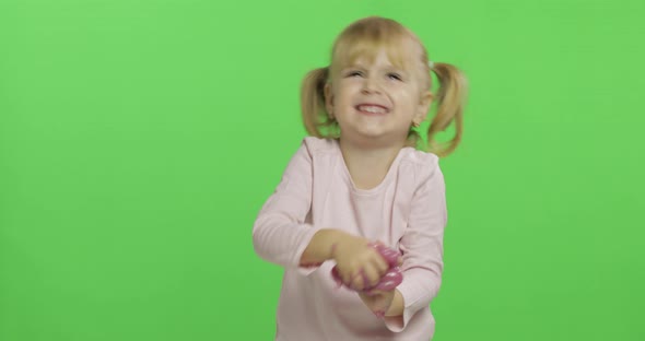 Kid Playing with Hand Made Toy Slime. Child Having Fun Making Pink Slime