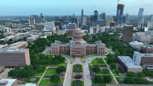 Austin Texas skyline and state capitol building. Aerial pullback reveal establishing shot.