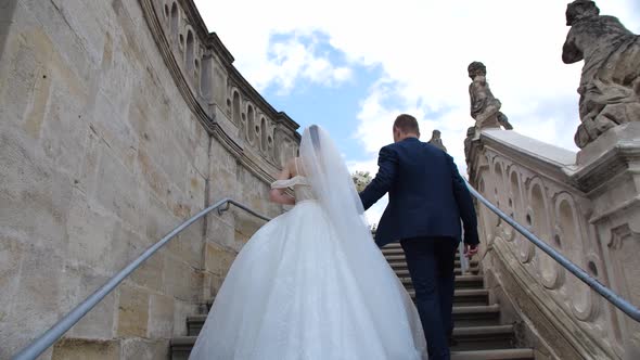 The Bride and Groom Climb the Stairs