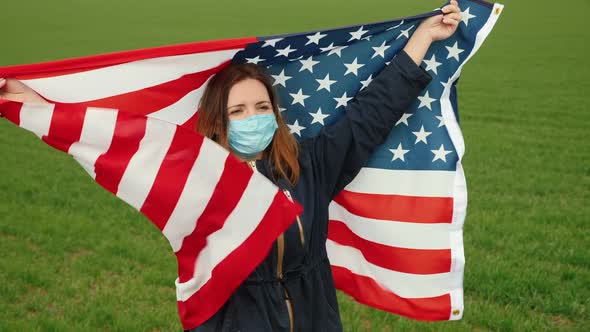 Woman in Medical Mask Holds Usa Flag in Her Hands