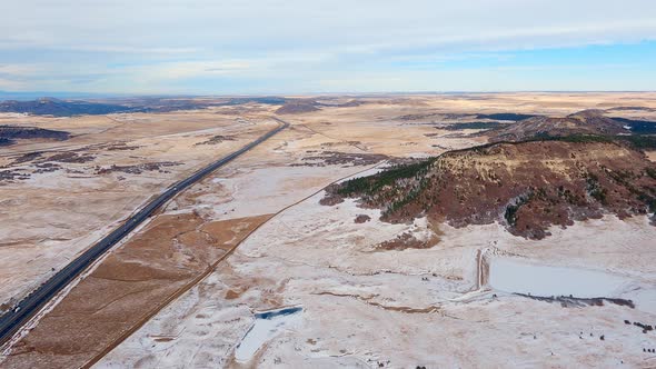 Airplane flight along I-25 near the town of Monument, Colorado during the winter