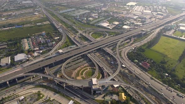 Aerial View of Highway Road Interchange with Busy Urban Traffic Speeding on Road