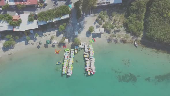 Aerial view of Kournas Lake, in Greece. Little pier with colorful pedal boats