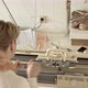 Back View of Woman Works behind a Knitting Machine - VideoHive Item for Sale