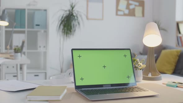 Laptop with Chroma Key Monitor on Office Table