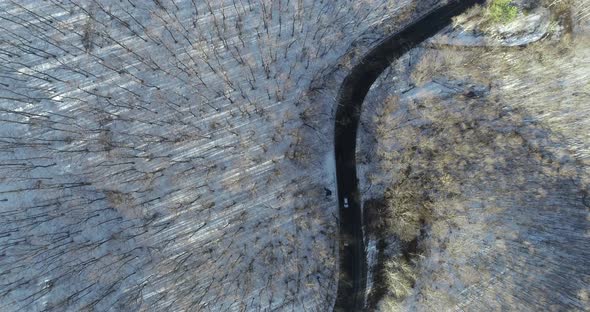 Awesome top down view of snowy forest. Road in mountains. Woods snowy forest.