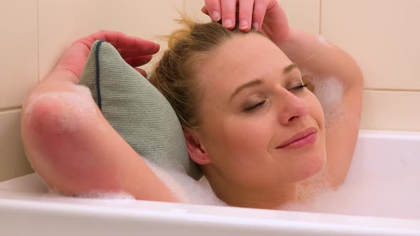 A Young Beautiful Woman Enjoys a Bath