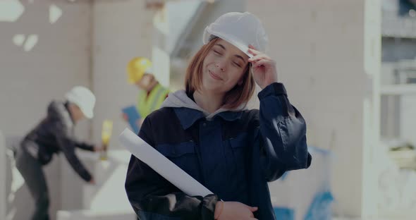 Smiling Female Architect Holding Blueprint