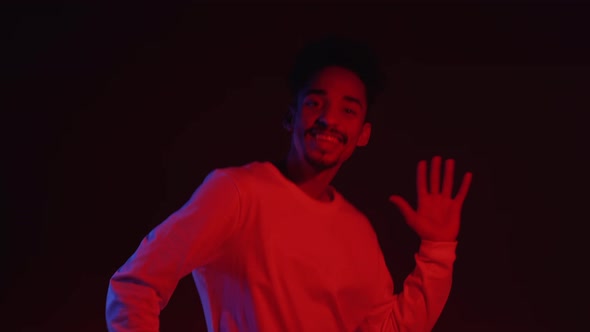 Active and Energetic African American Man in White Wear Smiling and Dancing