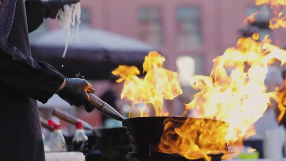 Street Food. Chef Cooking Thai Meal In Wok On Fire Outdoors