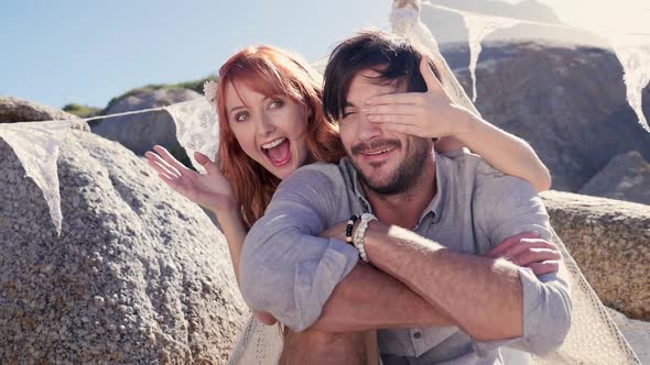 Woman covering man's eyes