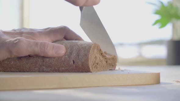 Slicing a Loaf of Bread in the Kitchen