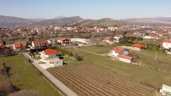 Birds eye view of suburban cottages built amidst beautiful mountains and vineyards. Podgorica. Monte