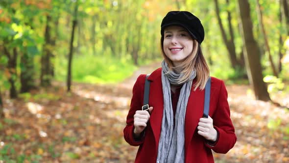 woman in coat in park.