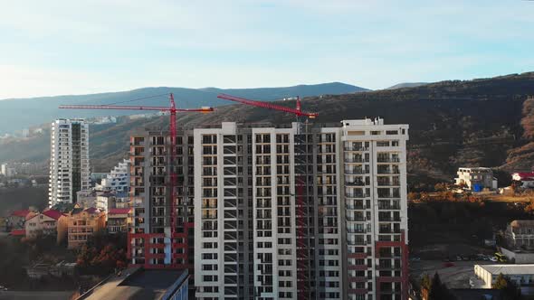Red Cranes With House Being Built