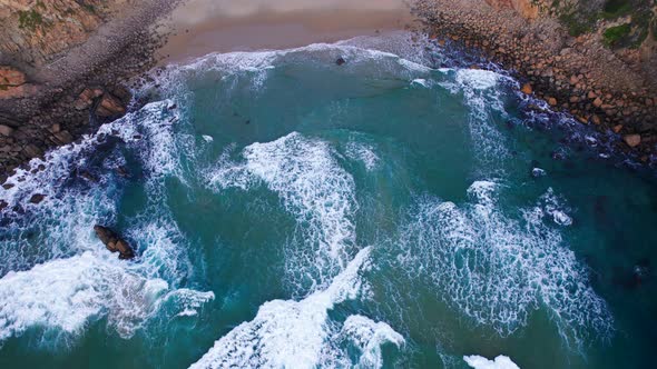 Aerial View of the Ocean Waves Hitting Against the Rocks