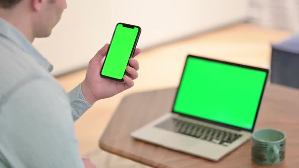 Using Smartphone with Chroma Screen Laptop with Green Chroma Screen in Background