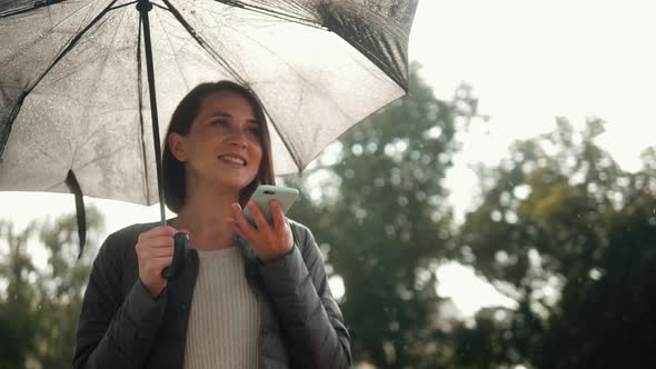 Evening Portrait of a Beautiful Young Woman in City Park. Stylish In Appearance. Girl Smiling on