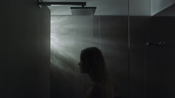 Woman under the shower. Calming down with water