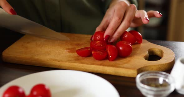 Step by step woman cooking feta cheese pasta, cutting tomatoes,