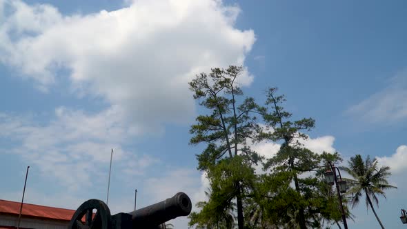 Old cannon from Dutch colonial era in Indonesia, pan down from sky