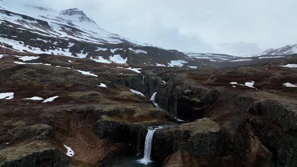 Scenic Klifbrekkufossar Waterfall In East Iceland - aerial pullback