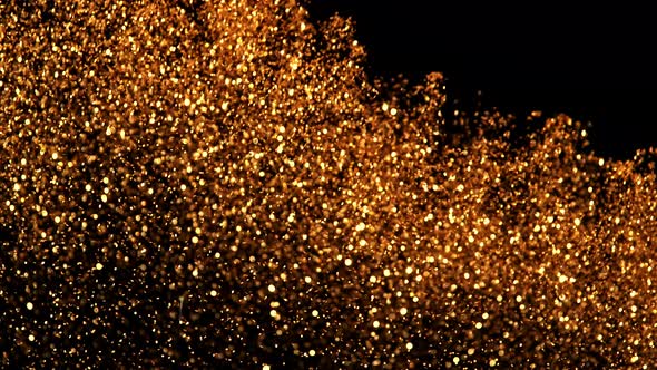 Super Slow Motion Shot of Golded Glitter Background. alt
