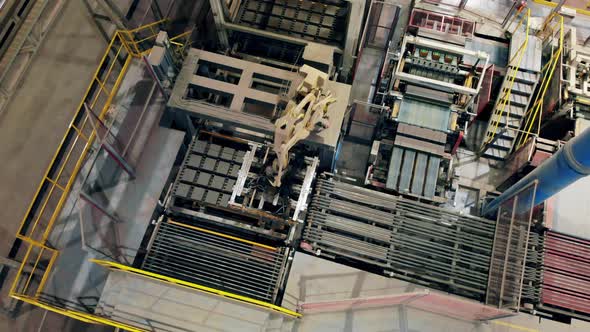 Top View of a Robotized Arm Moving Batches of Bricks at Amodern Factory Floor.