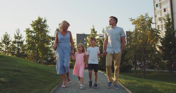 The Family Walks in the Park Along the Path