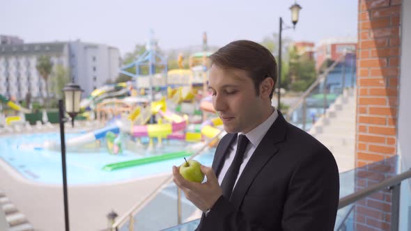 Businessman eating apple.