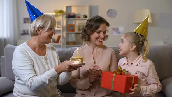 Young Woman Celebrating Birthday With Mother and Daughter, Family Togetherness