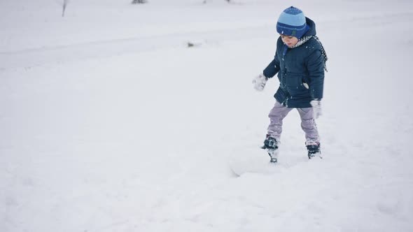 Little Boy Making Snowball for Snowman