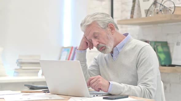 Tired Old Man Sleeping at Work