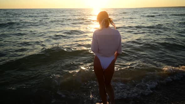 Young Woman Come To Water on Sunset at Sandy Beach, Island Holidays